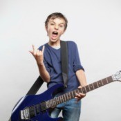 A boy playing an electric guitar.