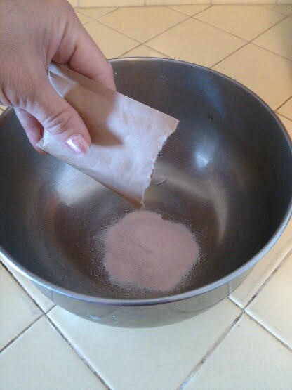 Adding jello powder to bowl.