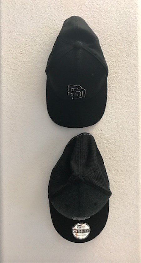 Two caps hanging in a row.
