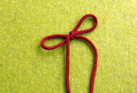 Birthday Parcel Card - Cut a long length of fine cord or string and tie it into a bow.