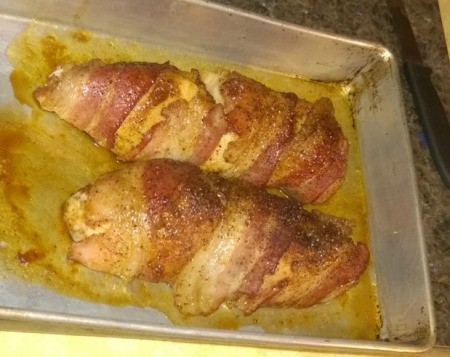 Baked sweet bacon chicken on baking sheet
