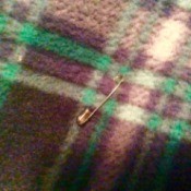 Avoid Static in Your Clothes - safety pin on plaid fabric