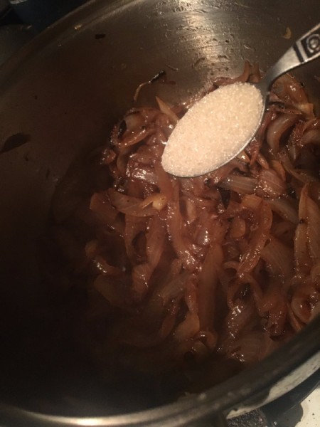 adding sugar to onions for French onion soup.