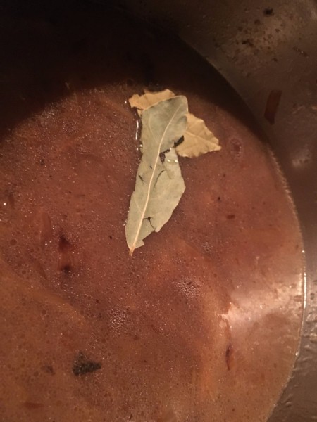 adding bayleaf to broth for French onion soup.