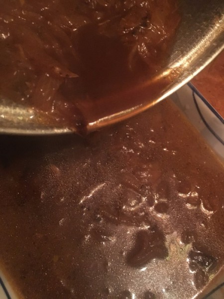 pouring soup in pan for oven for French onion soup.