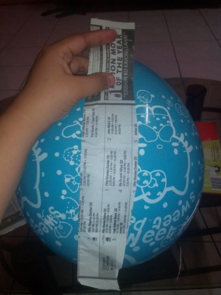 DIY Piñata - begin to glue strips of paper to balloon