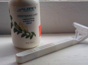 A razor and a bottle of body lotion, to be used for shaving.