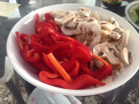 sliced red peppers and mushrooms in bowl