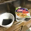 A noodle bowl being reused as a soap dish.