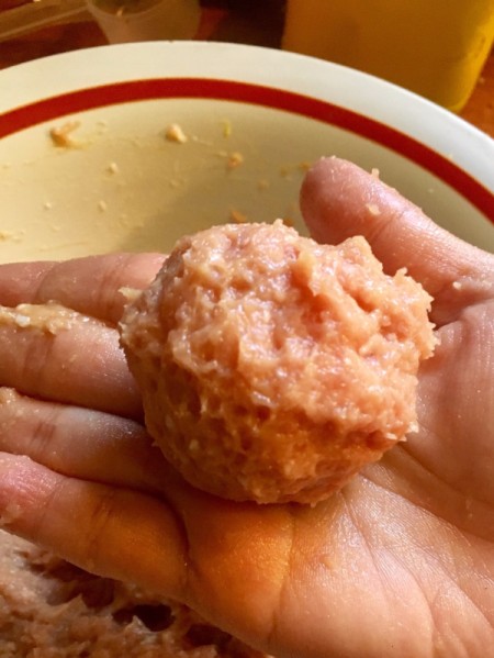 formed meatball in hand