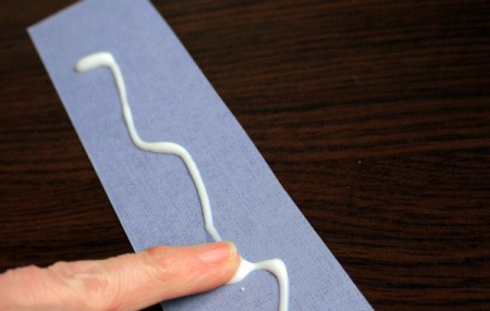 Punched Paper Bookmark - Apply and spread glue evenly over one side of the backing card.