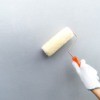 Hand glove holding paint brush
