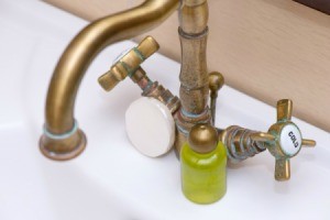 Antique faucet with green stains.