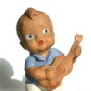 Old rubber doll of a boy playing a guitar.