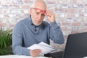 Older man reading his mail.