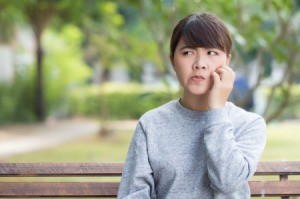 Woman scratching face.