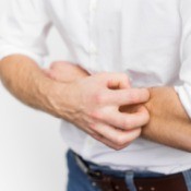 Man itching his arm.