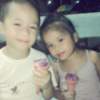 Two children eating ice cream cones.