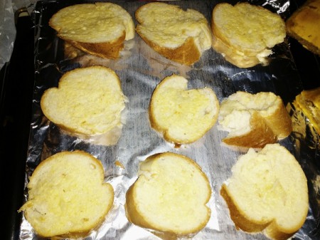 garlic bread pieces on foil lined pan