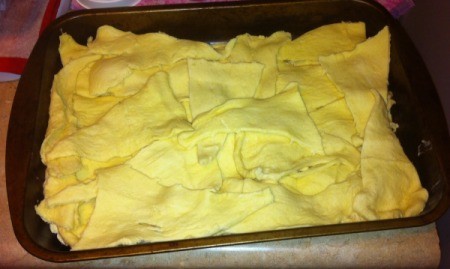 biscuit mix on top of chicken in baking pan