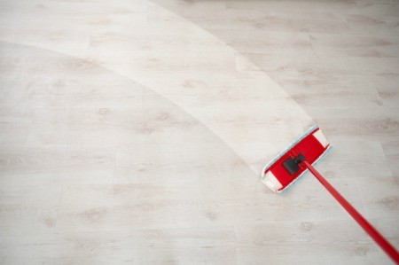 Mop cleaning a wooden floor.