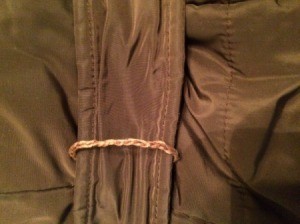 A belt loop on a jacket.