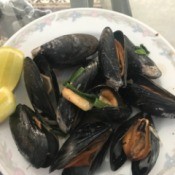 Stir Fry Green Mussels on plate with lemon