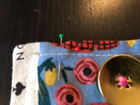 Fabric Cover for Baby Gate - marking snap placement with a pin