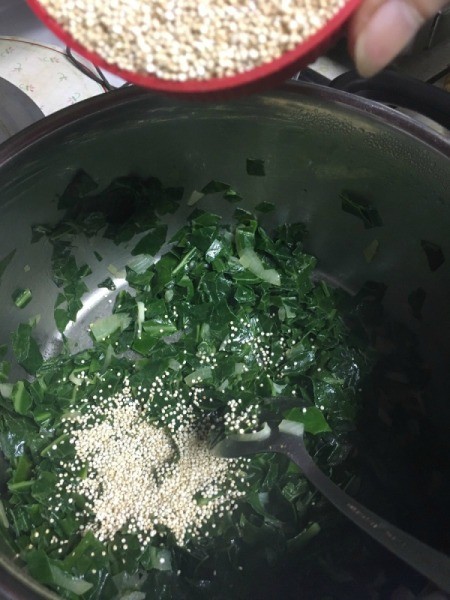 adding quinoa to Kale and Onion in pan