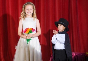 A boy and girl performing a magic show.