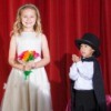 A boy and girl performing a magic show.