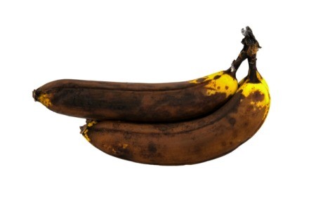 2 overripe bananas on white background.