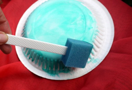 Fun Paper Plate Jelly Fish Decoration - painting the underside of the plate blue with a sponge brush
