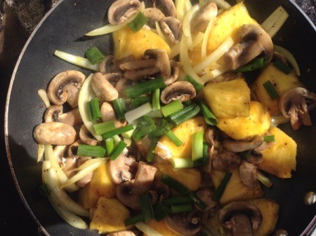 onions, mushrooms and pineapple in pan