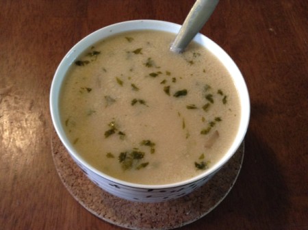 A bowl of creamy Tom Kha Gai soup.