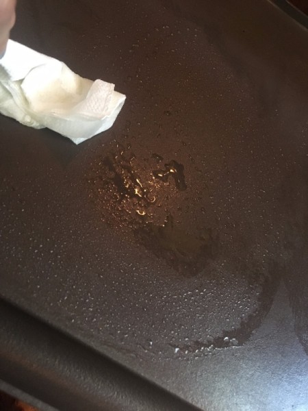 adding oil to cooking surface