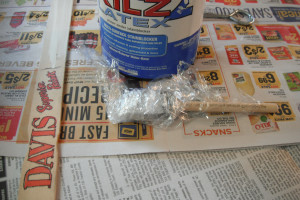 A paintbrush that is wrapped in plastic cling wrap.