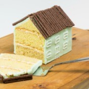 House shaped cake with the end slice off.