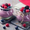 Blackberry Pudding topped with berries.