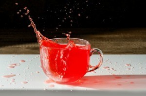 Cup of Kool-Aid splashing out onto the table.