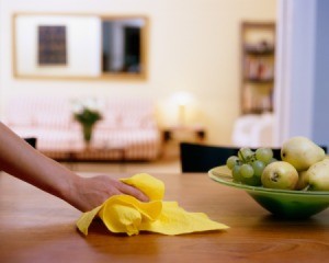 Hand wiping down a dining room table