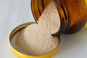 Jar of yeast spilling out onto cap.