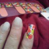 Placing nail decals on acrylic nails.