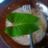 dipping water spinach leaf in beaten egg