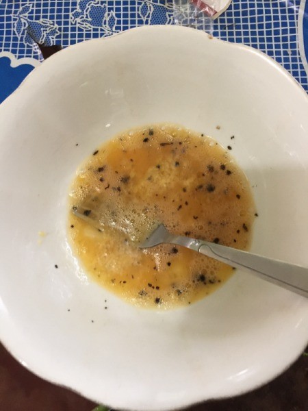 mixing egg, salt and pepper in bowl
