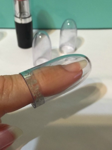 Use Lipstick Cap as Thimble - clear plastic cap over finger