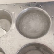 Ice cubes made in a metal muffin tin.