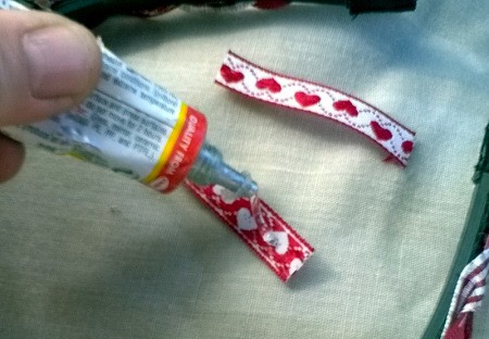 Revamp an Old Headband with Ribbon - cut two short pieces of ribbon from the trimmed ends and apply glue to them