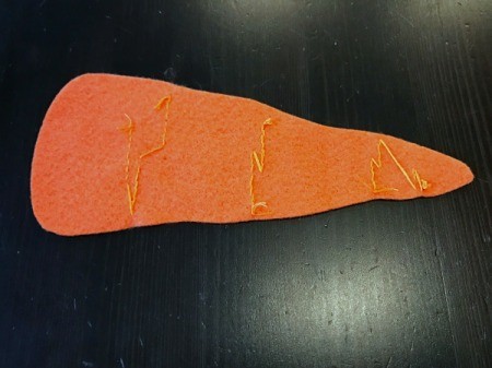 Felt Carrot Money Pocket - backside of carrot showing continuous stitching where possible