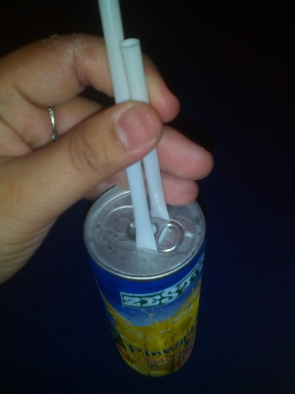 A straw placed under a ring tab to open it.